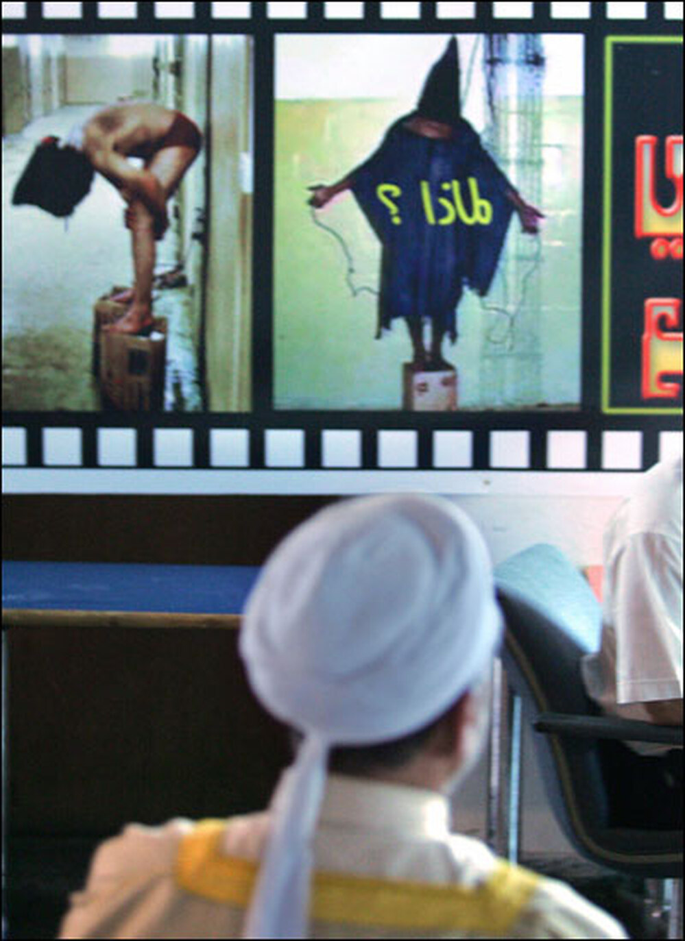 An Iraqi man looks at photos of prisoners. Credit: Karim Sahib/AFP/Getty Images.