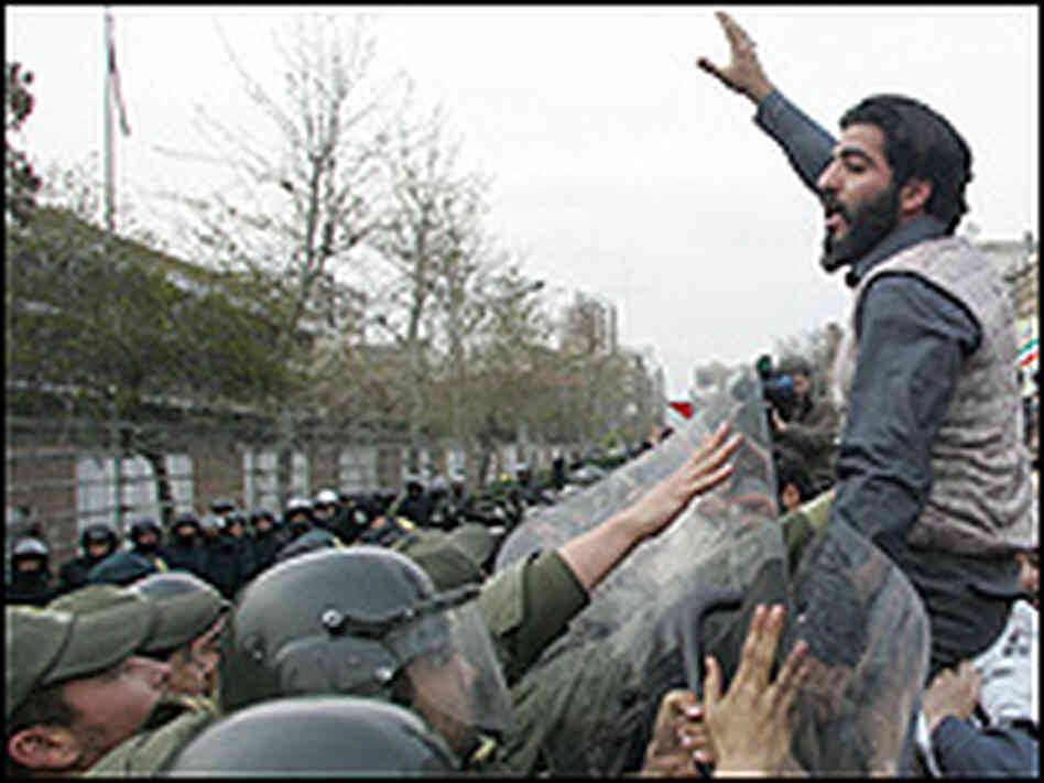 Iranian riot police halt student protesters outside British embassy.