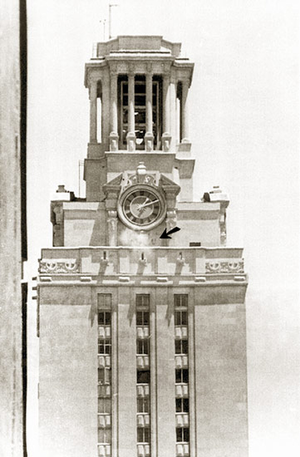 Police bullets kick up dust around the clock on the University of Texas tower.