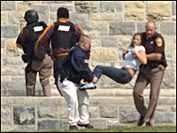 An injured occupant is carried out of Norris Hall at Virginia Tech in Blacksburg, Va., Monday, April 16, 2007. Shootings in a dorm and classroom at Virginia Tech resulted in multiple fatalities, police say. (AP Photo/The Roanoke Times, Alan Kim.