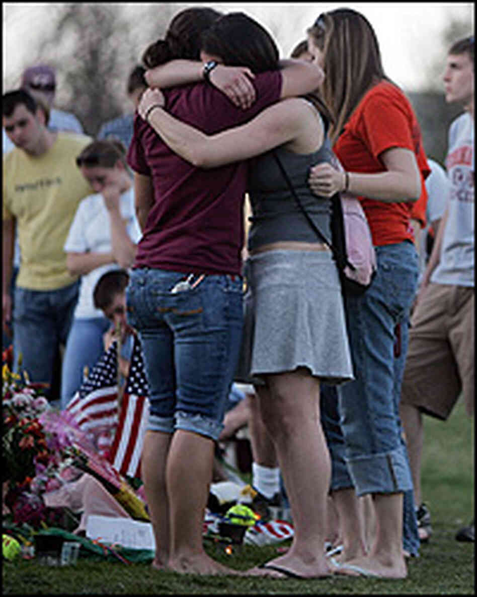 Mourners gather Sunday at a makeshift memorial on the Virginia Tech campus. Mourners gather Sunday at a makeshift memorial on the Virginia Tech campus.