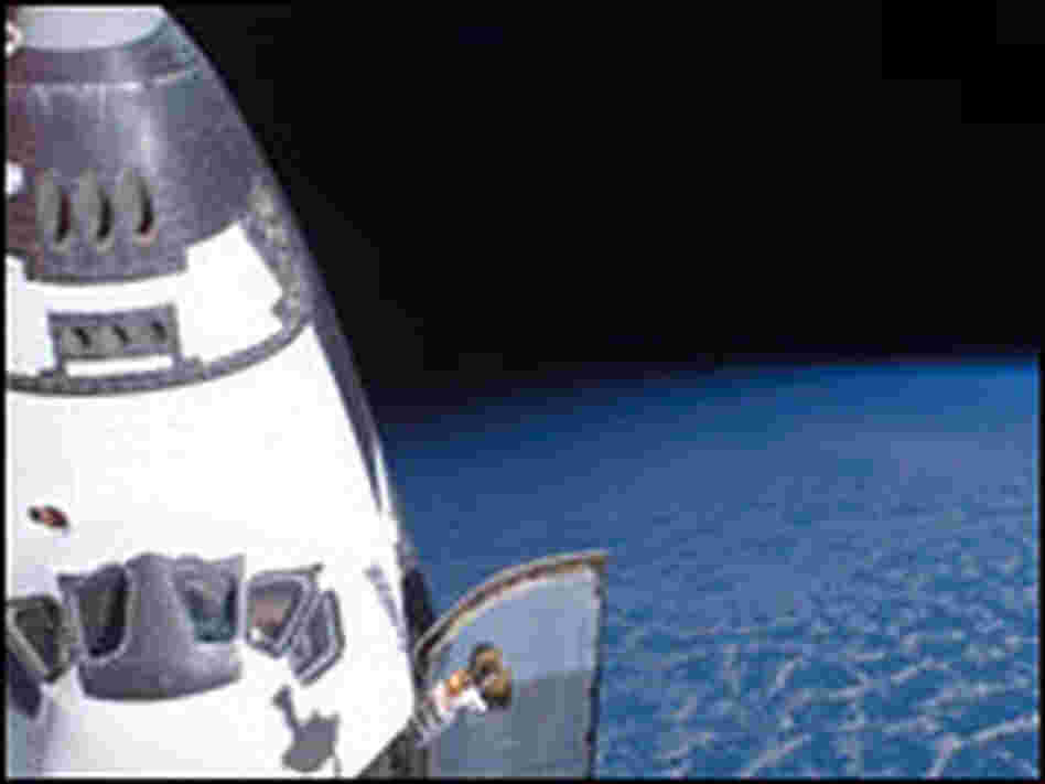 Space Shuttle Endeavour backdropped by the blackness of space.