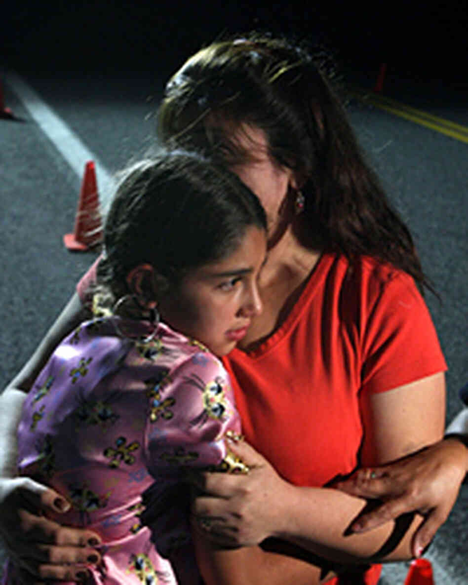 Maria Lerma hugs her daughter Adilene as they wait to hear news about her husband, Natalio. Maria Lerma hugs her daughter Adilene as they wait to hear news about her husband, Natalio.