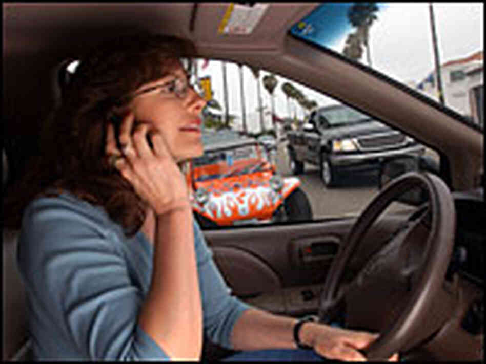 Catherine Singer talks on a cell phone while pulling into traffic. Catherine Singer talks on a cell phone while pulling into traffic.
