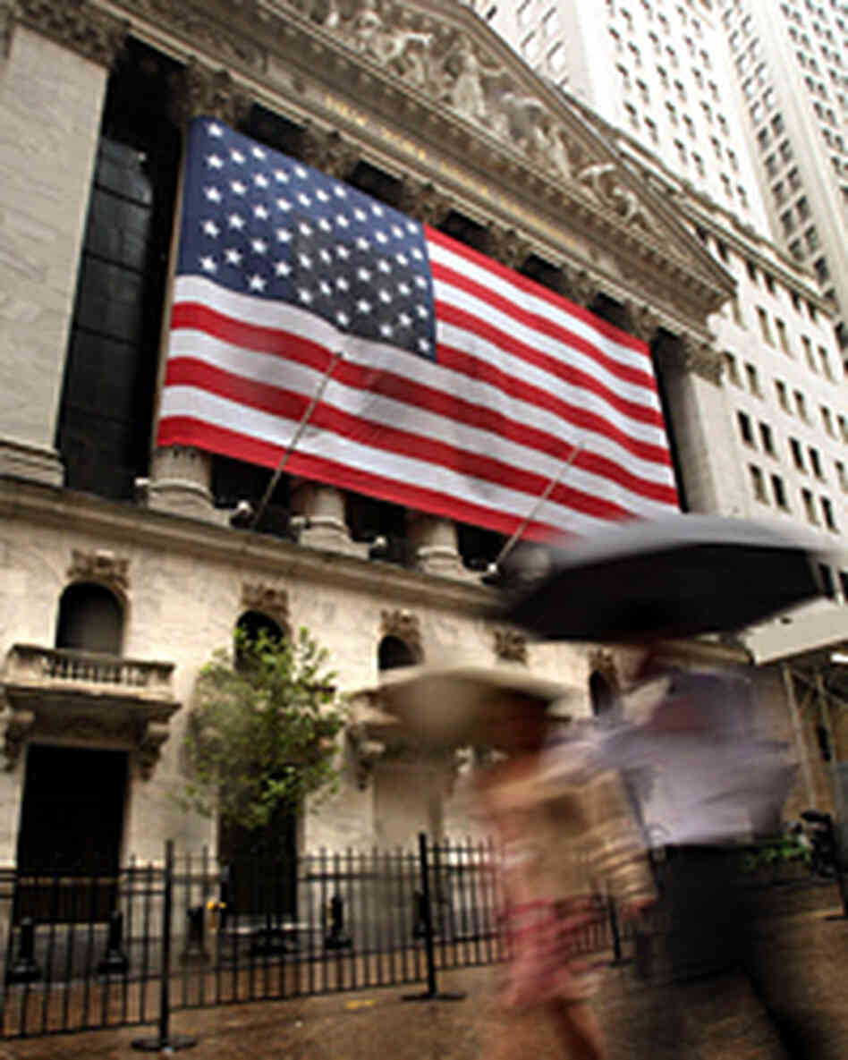 People walk in front of the New York Stock Exchange. People walk in front of the New York Stock Exchange.