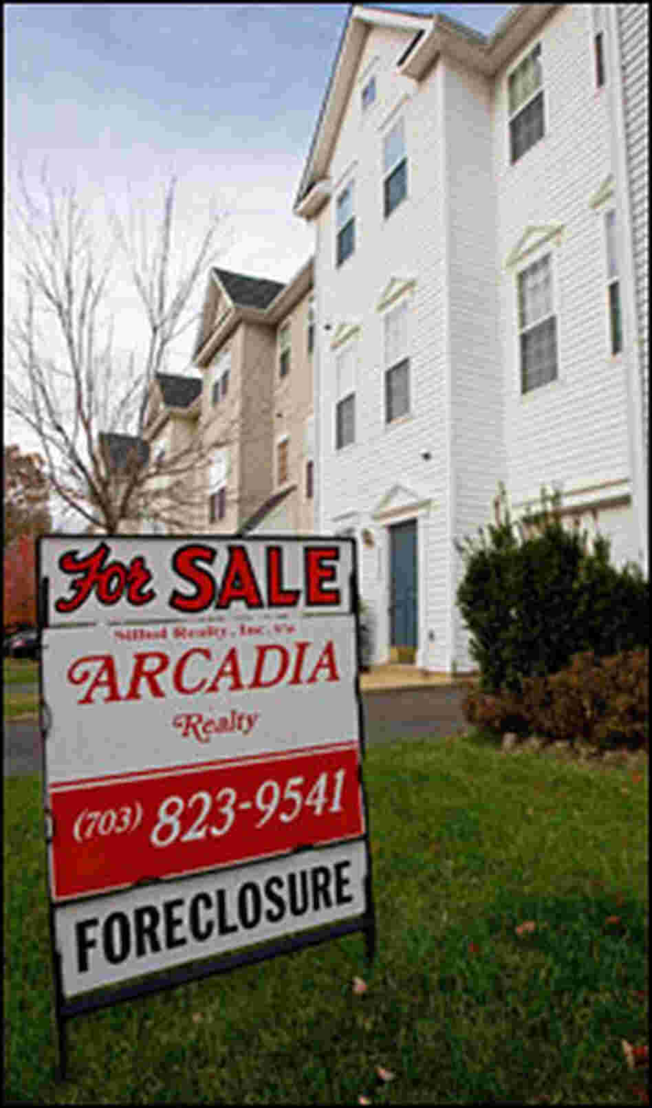 A sign advertises that a home for sale is in foreclosure. A sign advertises that a home for sale is in foreclosure.
