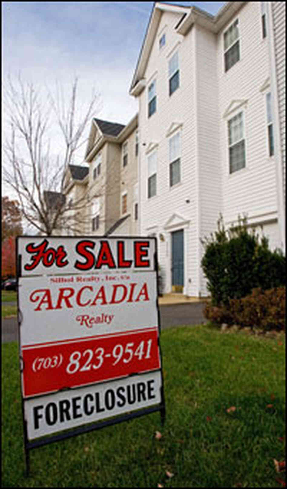 A sign advertises that a home for sale is in foreclosure. A sign advertises that a home for sale is in foreclosure.