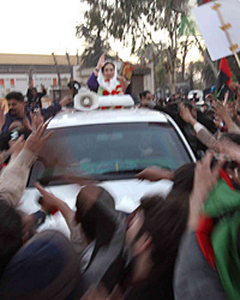 Benazir Bhutto waves from her car just seconds before being attacked. Benazir Bhutto waves from her car just seconds before being attacked.