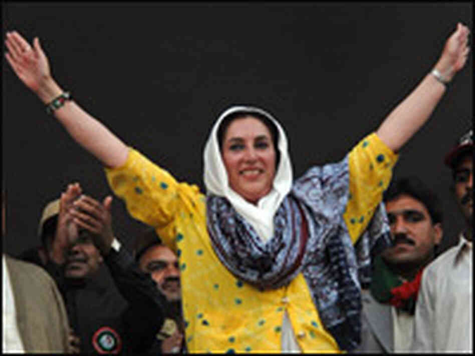 Bhutto waves to the crowd during an election campaign meeting.