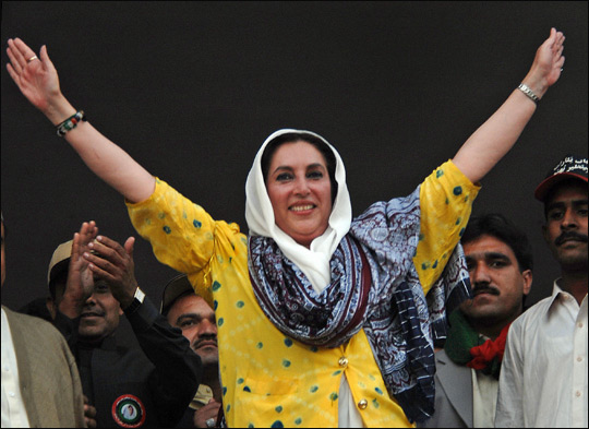 Bhutto waves to the crowd during an election campaign meeting.