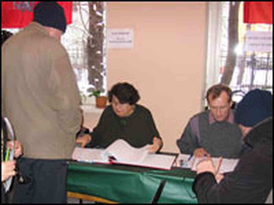 Russians register to vote in Sunday's elections at a ballot station in a central Moscow school.