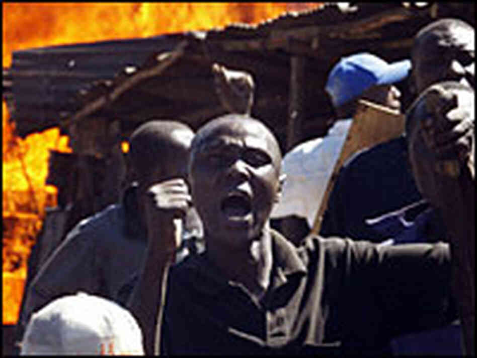 Residents of the Mathare slum in Nairobi, Kenya, shout at demonstrators Tuesday. Residents of the Mathare slum in Nairobi, Kenya, shout at demonstrators Tuesday.