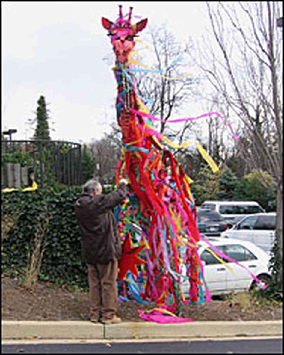 A teacher hangs a scarf honoring educator Sally Smith on a statue outside the school she founded. A teacher hangs a scarf honoring educator Sally Smith on a statue outside the school she founded.