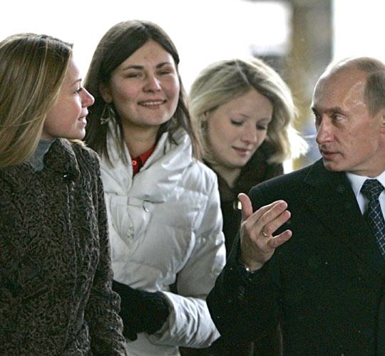 Russian President Vladimir Putin talks with voters at a polling station in Moscow, Russia on Sunday.