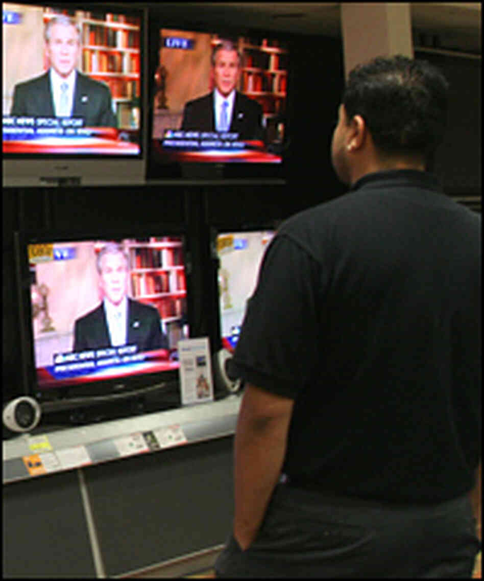 A man watches President Bush's address on his plan for the war in Iraq at an electronics store. A man watches President Bush's address on his plan for the war in Iraq at an electronics store.