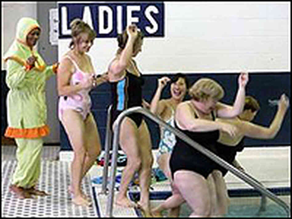 A fully dressed Muslim woman waits in line to jump in a swimming pool. A fully dressed Muslim woman waits in line to jump in a swimming pool.