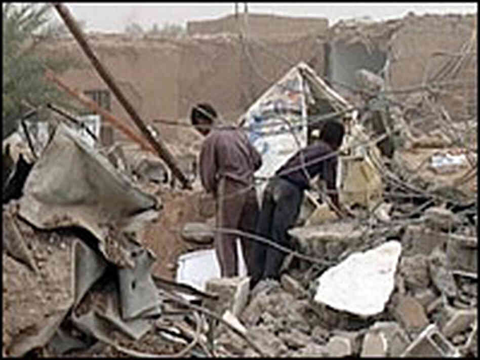 Iraqis inspect destruction at the site of a truck bomb blast in the village of Armili. Iraqis inspect destruction at the site of a truck bomb blast in the village of Armili.