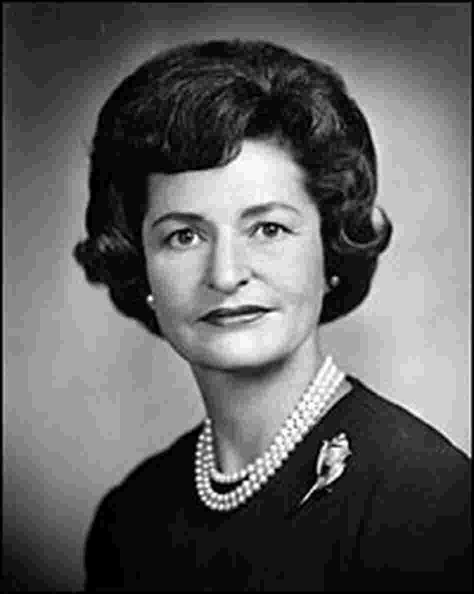Headshot of Lady Bird Johnson wearing a pearl necklace and a brooch