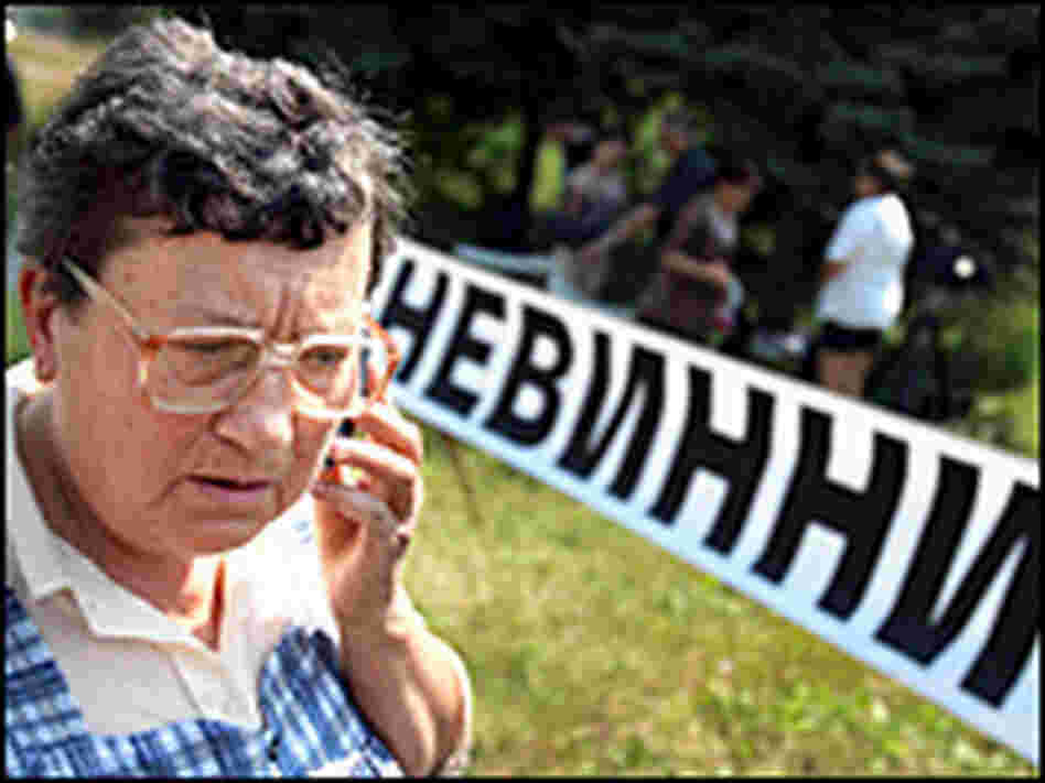 Mother of jailed nurse stands next to banner reading "Innocent"/Getty. Mother of jailed nurse stands next to banner reading "Innocent"/Getty.