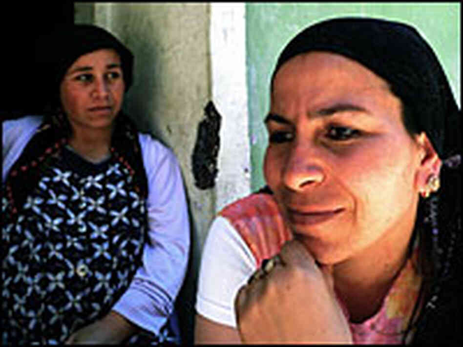Roma, or gypsies, sit on the doorstep. Roma, or gypsies, sit on the doorstep.