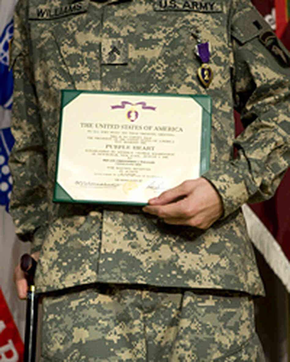Pfc. Christopher Williams holds a certificate during a June Purple Heart ceremony in Washington. Pfc. Christopher Williams holds a certificate during a June Purple Heart ceremony in Washington.
