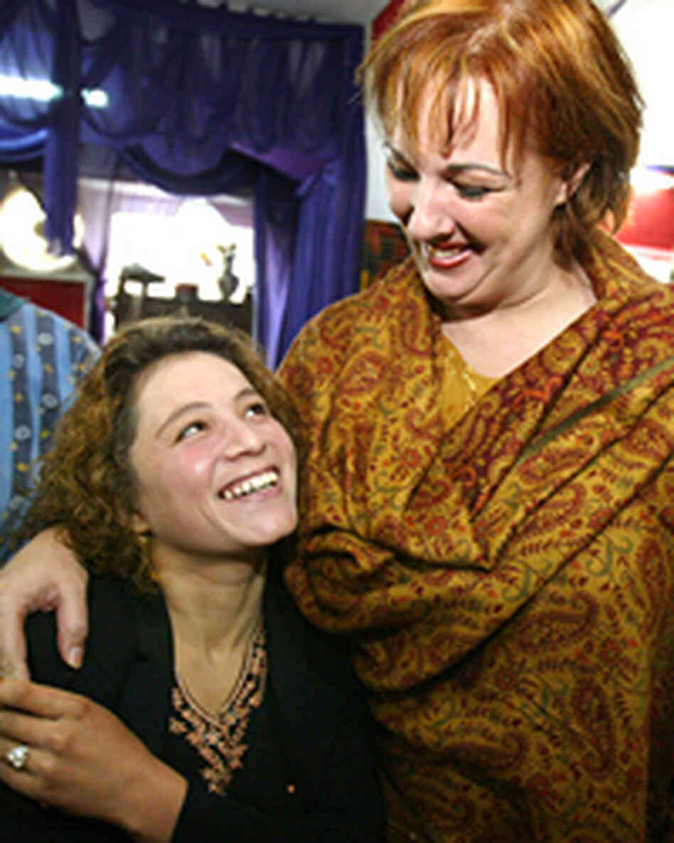 American hairdresser Debbie Rodriguez (R) hugs a student beautician at the Kabul Beauty American hairdresser Debbie Rodriguez (R) hugs a student beautician at the Kabul Beauty