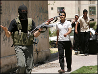 Civilians Palestinian leave the area during clashes between Hamas and Fatah militants.