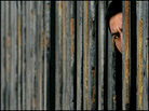 A Mexican man peers through the U.S.-Mexico border wall in San Ysidro, Calif. A Mexican man peers through the U.S.-Mexico border wall in San Ysidro, Calif.