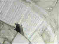 NASA television image shows a tear in the thermal blanket on the space shuttle NASA television image shows a tear in the thermal blanket on the space shuttle