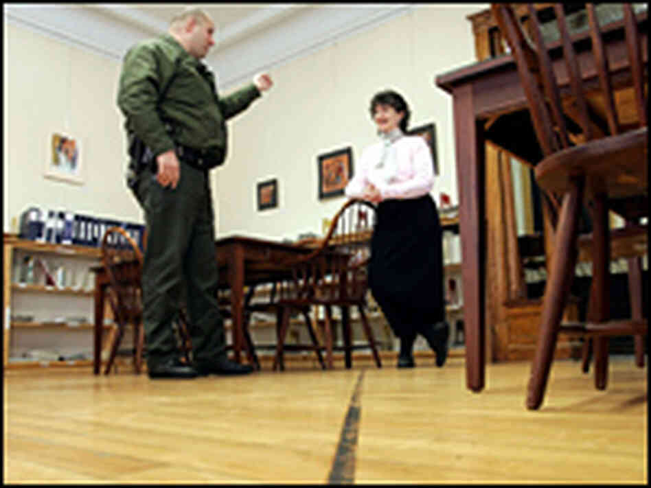 A Border Patrol agent speaks to Nancy Rumery in the Haskell Free Library and Opera House
