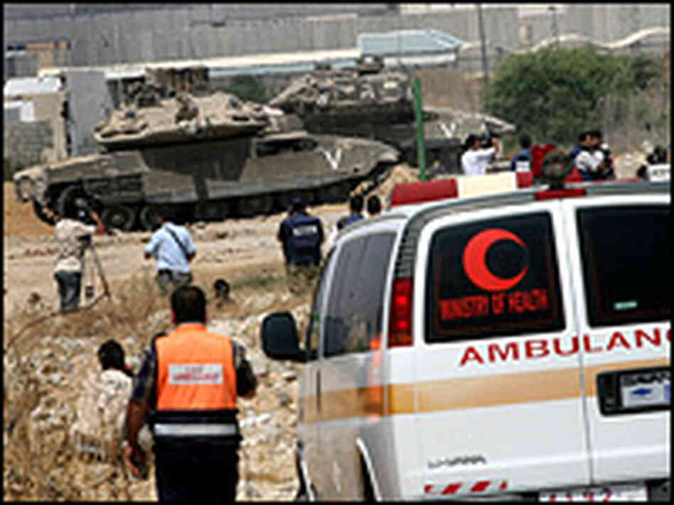 Ambulance crews wait to evacuate ill Palestinians to Israel for medical treatment. Ambulance crews wait to evacuate ill Palestinians to Israel for medical treatment.