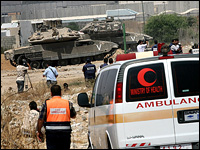 Ambulance crews wait to evacuate ill Palestinians to Israel for medical treatment.