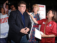 Michael Moore greets health care workers  at the premiere of 'Sicko'.