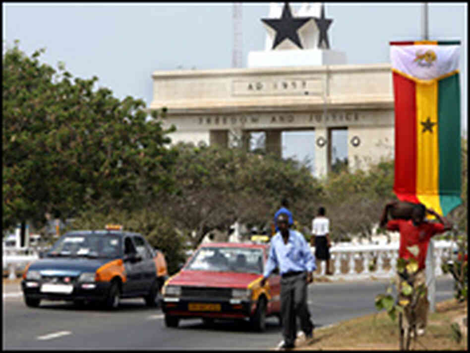Motorists pass a monument dedicated to Ghana's independence in the capital of Accra.