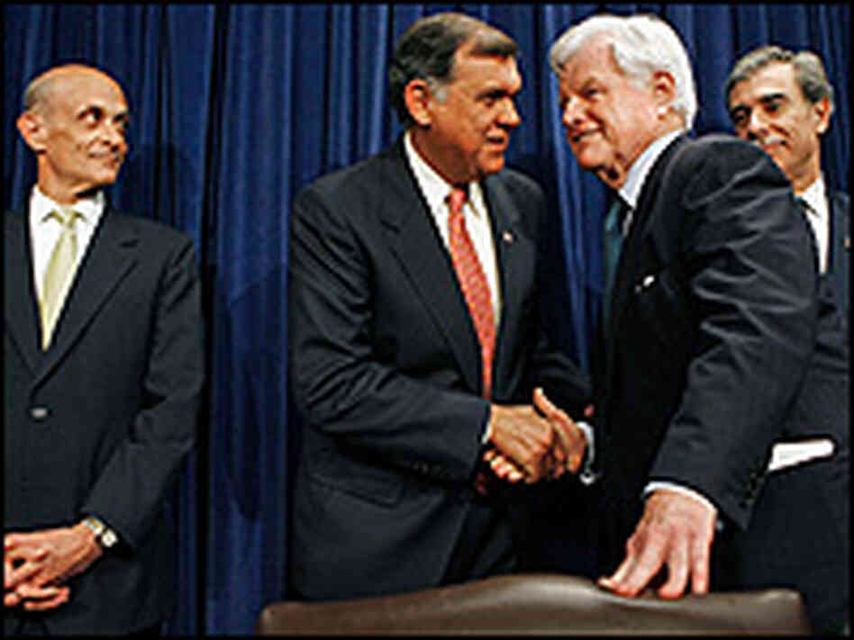 Sen. Mel Martinez and Sen. Ted Kennedy shake hands at a news conference on the immigration deal.