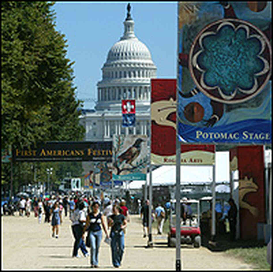 Capitol building looms over a Smithsonian exhibit on the National Mall.