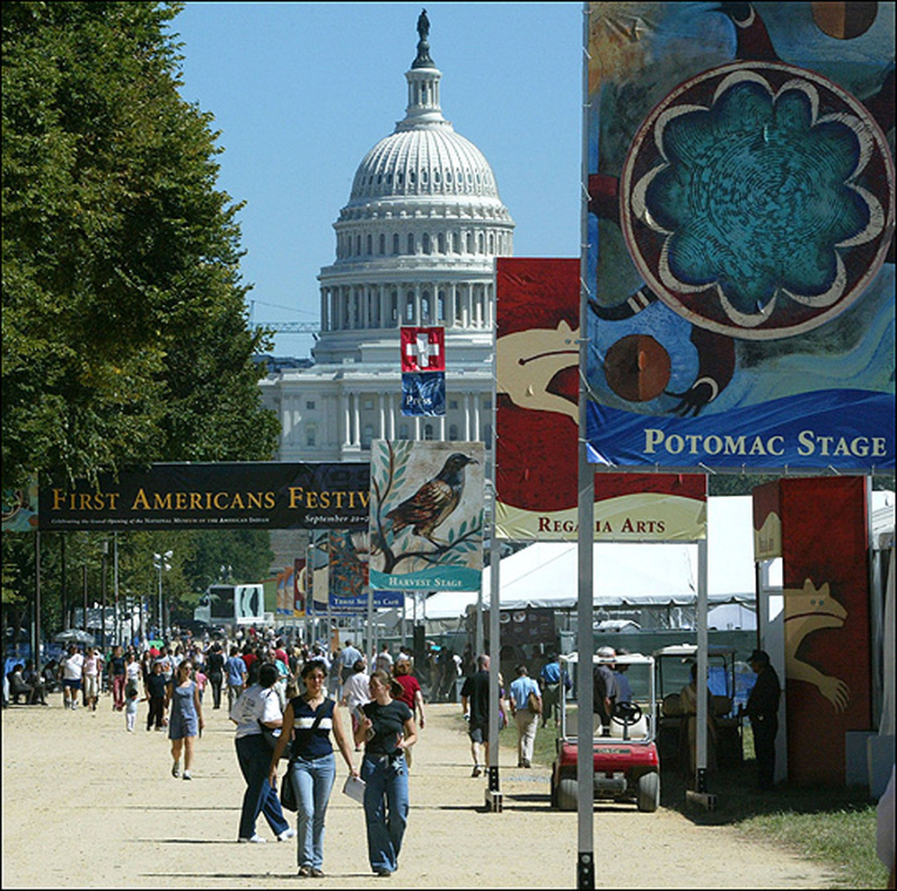 Capitol building looms over a Smithsonian exhibit on the National Mall.
