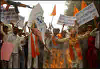 Hindu activists burn an effigy and a caricature of M.F. Husain. Hindu activists burn an effigy and a caricature of M.F. Husain.
