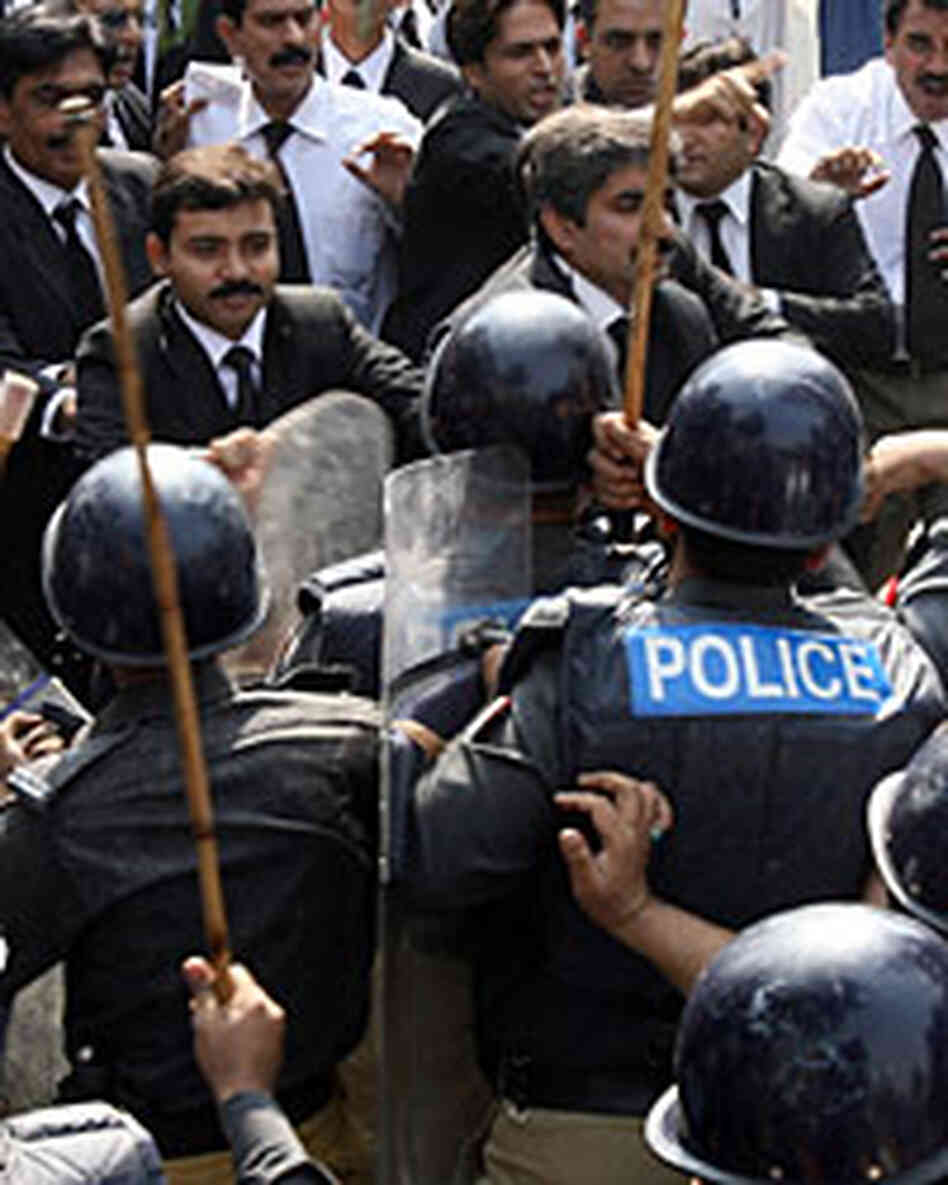 Pakistani riot police scuffle with lawyers protesting the declaration of emergency rule. Pakistani riot police scuffle with lawyers protesting the declaration of emergency rule.