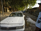An Iraqi policeman stands by a bullet-riddled car of two women allegedly shot dead by guards. An Iraqi policeman stands by a bullet-riddled car of two women allegedly shot dead by guards.