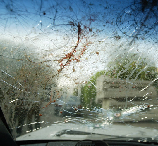 The bullet-riddled windscreen of a car of two women allegedly shot by private security guards.