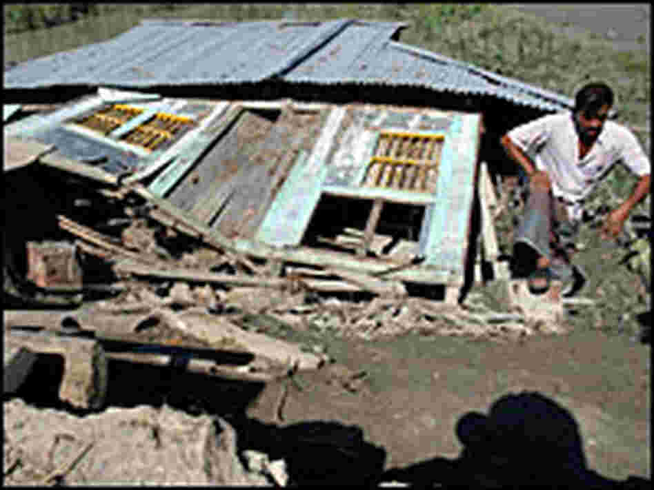 A man inspects his collapsed shop at a market in Gorjonbunia village in Bangladesh on Monday.