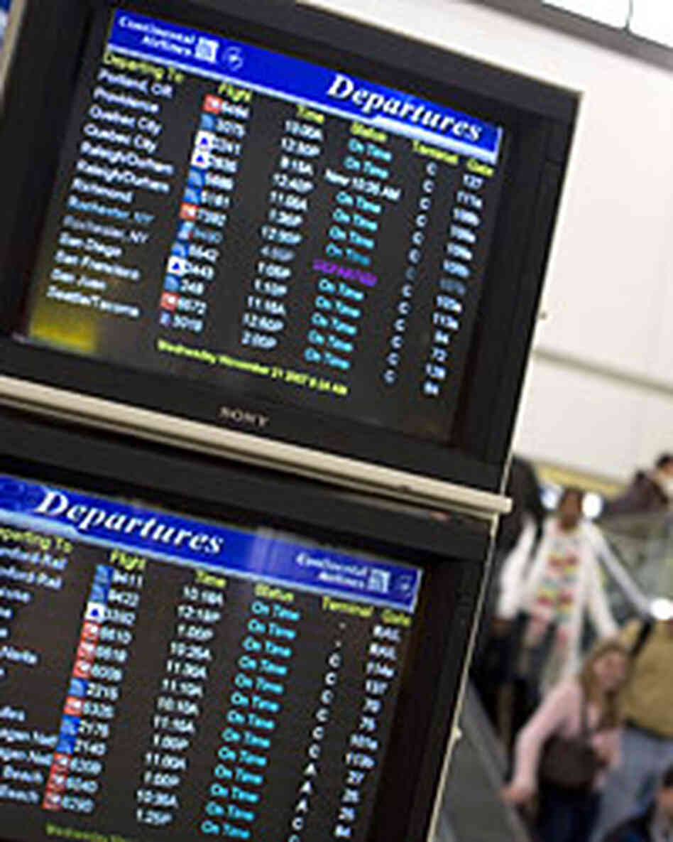 Monitors show departing flights at Newark Liberty International Airport in Newark, N.J.. Monitors show departing flights at Newark Liberty International Airport in Newark, N.J..