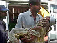 A man carries an injured child to the hospital after a suicide boming in Bannu, Pakistan, on Monday. A man carries an injured child to the hospital after a suicide boming in Bannu, Pakistan, on Monday.