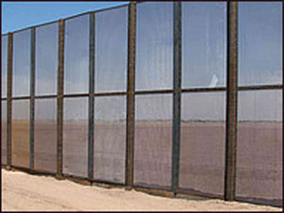 Fences like the one shown will be built in towns and on farms along the border. Fences like the one shown will be built in towns and on farms along the border.