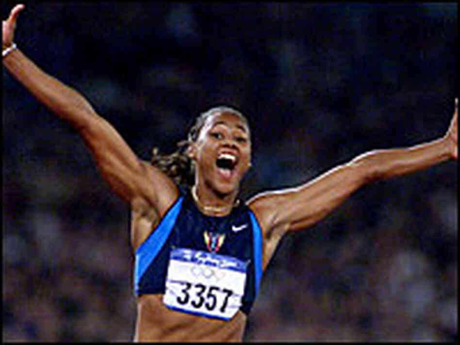 Marion Jones crosses the finish line to win the gold medal in the 2000 Olympics.