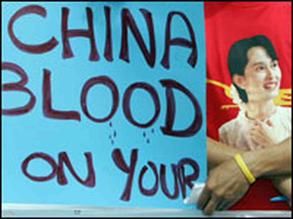 Myanmar activists display an anti-Chinese slogan and portrait of Aung San Suu Kyi. Myanmar activists display an anti-Chinese slogan and portrait of Aung San Suu Kyi.