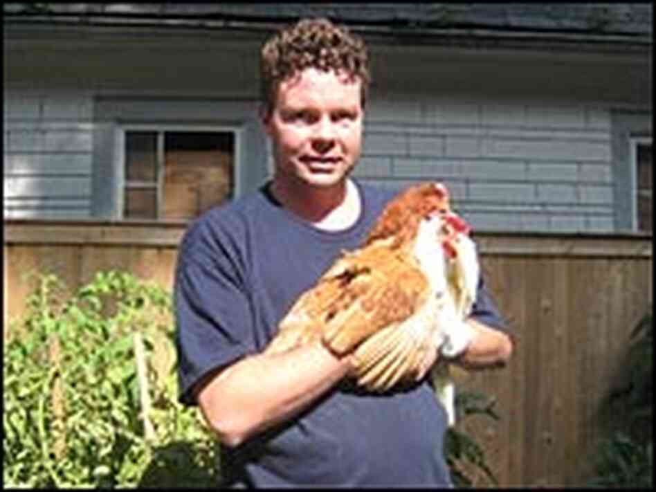 Manny Howard holds one of his chickens on his tiny Brooklyn farm.