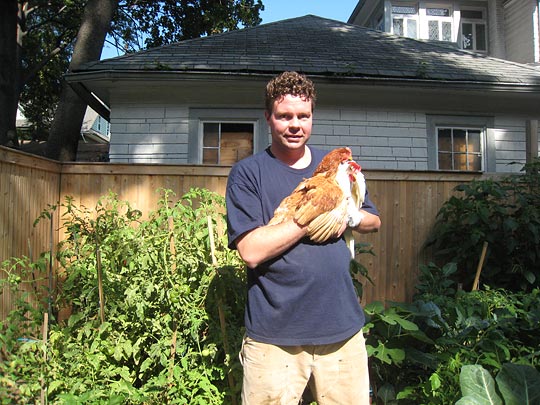 Manny Howard holds one of his chickens on his tiny Brooklyn farm.