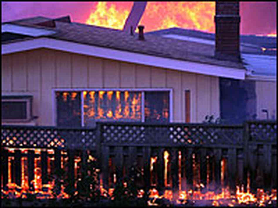 A home goes up in flames near Fallbrook, Calif., on Monday.